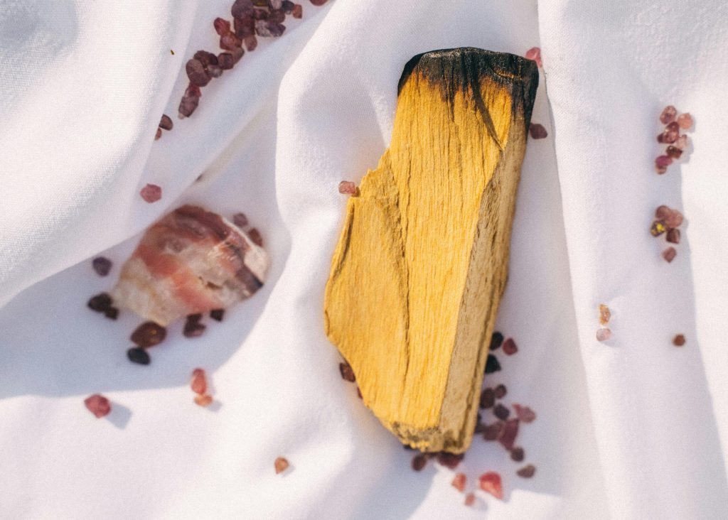 Hand-cut palo santo stick on white linen