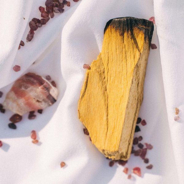 Hand-cut palo santo stick on white linen