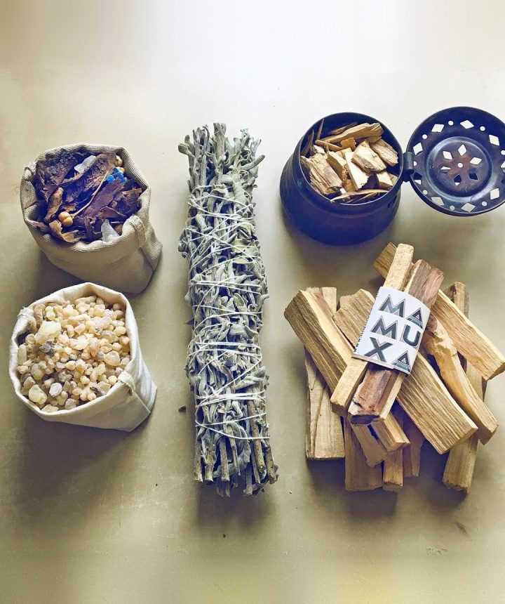 Bakhoor and frankincense resin in cotton pouches, an Anatolian sage bundle, palo santo sticks and a copper incense burner